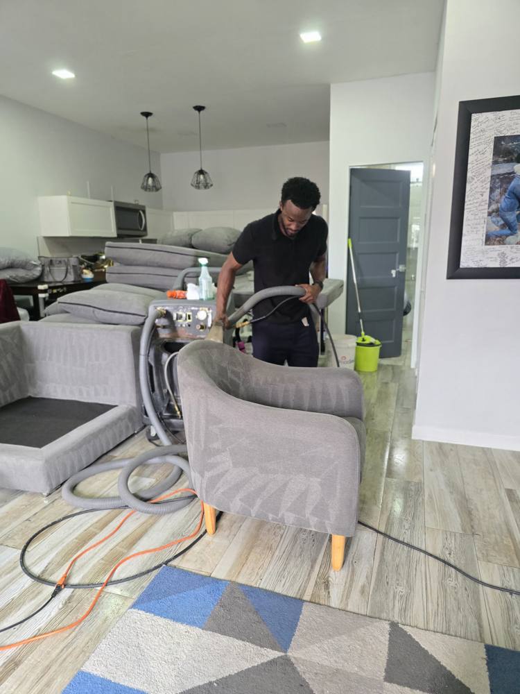 Super Fresh technician deep cleaning a sofa in a client's living room